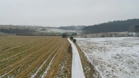 Flying over cold, snowy, winter landscape, drone stock footage Stock Footage 140034122