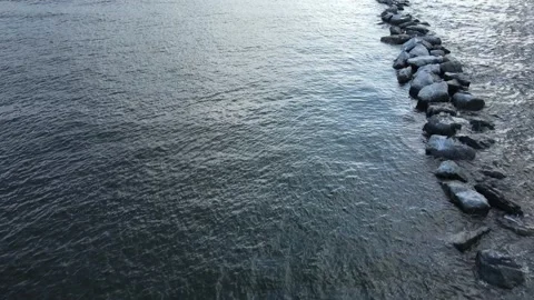 Flying Over A Column Of Break Water Rocks In A River Stock Footage 161676115