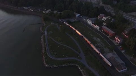 Flying over a commuter train and following its motion. Video stock 64145496