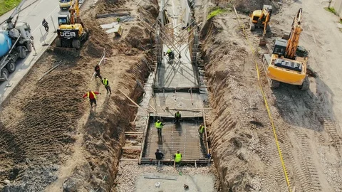 Flying over the construction site, building a new road and street in urban area. Vidéo 99042322