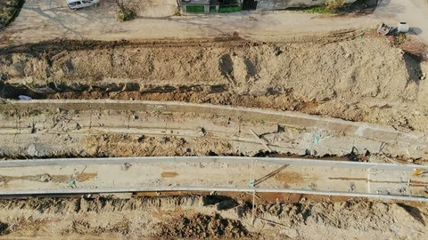 Flying over the construction site, building a new road and street in urban area. Video stock 99042359