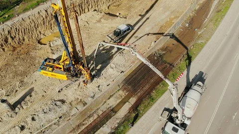 Flying over the construction site, building a new road and street in urban area. 動画素材 99045654