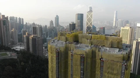 Flying over construction site reveals modern skyline Hong Kong Stock Footage 109474673