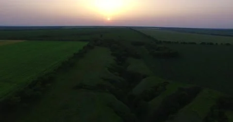 Flying over the countryside during the sunset Stock-Footage 64414093