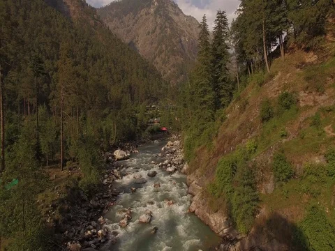 Flying Over Creek in Valley Stock Footage 81002889