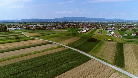 Flying over crop fields with Zagreb, Croatia in distance Stock Footage 100723219
