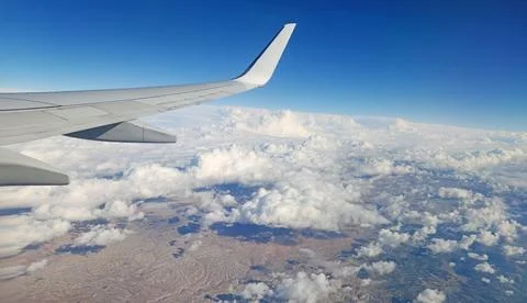 Flying over the cumulus clouds Stock Photos