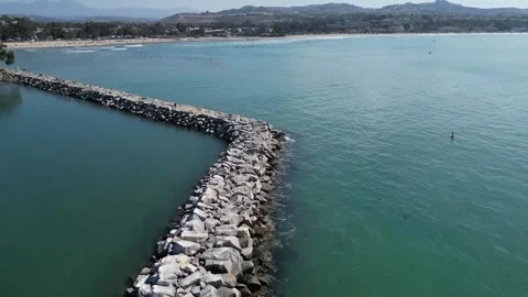 Flying over the Dana Point's breakwater overseeing the beach Stock Footage 205586867