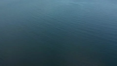 Flying over dark blue ocean sea surface. Top down aerial view. Stock Footage 164592580