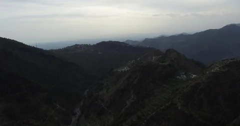 Flying over dark green mountaintops Stock Footage 80951814