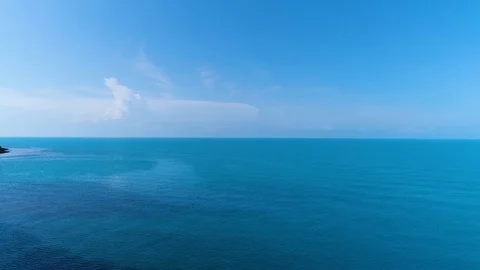 Flying over the deep, undulating sea at dawn. The vast blue water and the Stock Footage 111158577