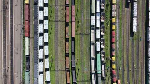 Flying over the depot station of freight trains with cargo ready for delivery Stock Footage 163671806