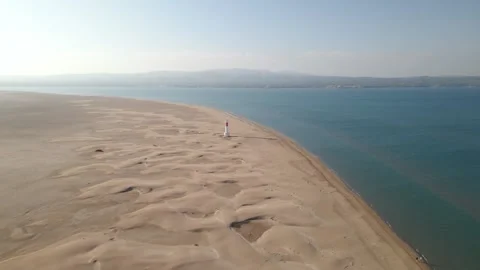 Flying over the desert from the lighthouse of Delta de l'Ebre natural park Stock Footage 260878998