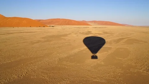 Flying over the desert in Namibia in a hot air balloon Stockbeeldmateriaal 115966780