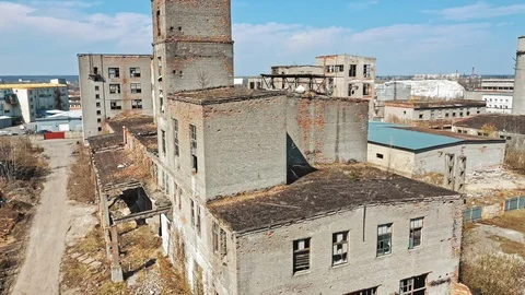 Flying over the desolate place with many abandoned buildings in a city Stock Footage 106714587