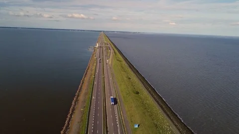 Flying over dike along traffic in the Netherlands. Stock Footage 78092560