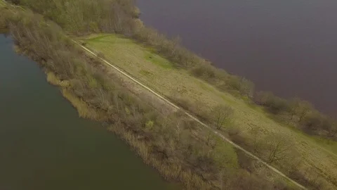 Flying over a dike between two lakes Video stock 91751593