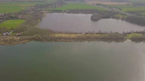 Flying over a dike between two lakes Stock Footage 91751700