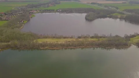 Flying over a dike between two lakes Stock Footage 91751755