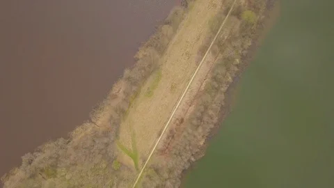 Flying over a dike between two lakes Stock Footage 91752094