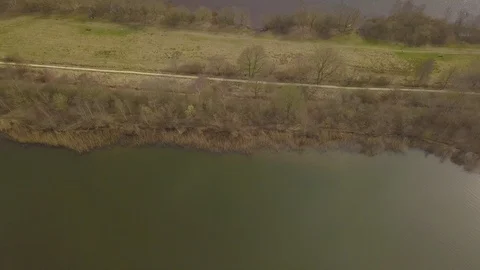 Flying over a dike between two lakes Stock Footage 91752228