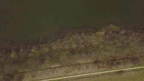 Flying over a dike between two lakes Stock Footage 91752392