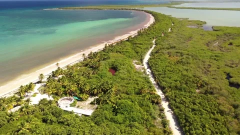 Flying over Dirt Road towards tropical ocean in Riviera Maya Boca De Paila 5 Stock-Footage 137428656