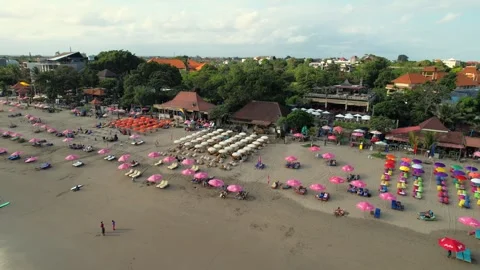Flying Over Double Six Beach Packed with Rental Umbrellas in Peak Summer Stock Footage 247498923