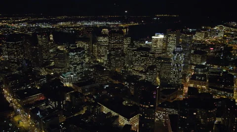 Flying over downtown Boston at night toward Financial District and waterfront. Stock Footage