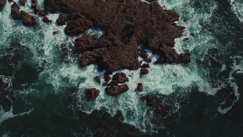 Flying over dramatic foam sea wave beating on natural cliff aerial rotation shot Stock Footage 127603080