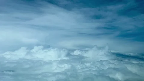 Flying over a dramatic stormy sky plenty of clouds. A pilot’s perspective Stock Footage 242394486