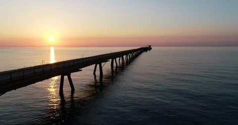 Flying over drone Pantalan Harbor Bridge in a Mediterranean sunrise Stock Footage 124217545