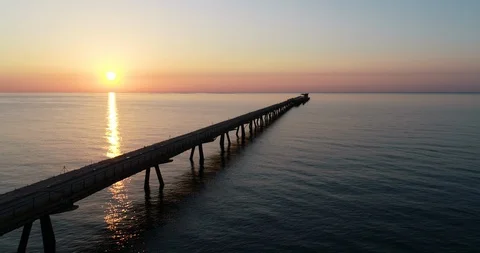 Flying over drone Pantalan Harbor Bridge in a Mediterranean sunrise Stock Footage 124218147