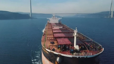 Flying over Dry Cargo Ship. Bulbous bow, forecastle, red fore deck, hatch covers Stock Footage 145994064