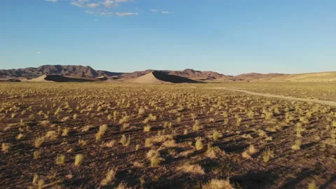Flying over dry desert and sagebrush towards tonopah sand dunes Stock Footage 200007487