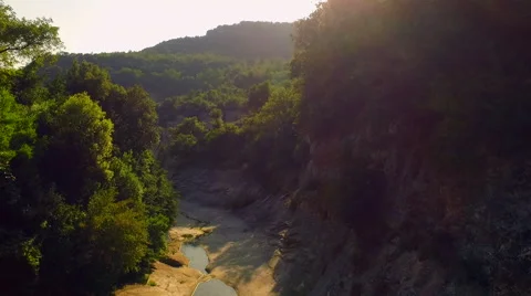 Flying over a dry river until its fall by a waterfall 動画素材 68535264