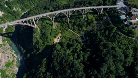 Flying over Durdevica (Djurdjevic) bridge and Tara river canyon. Montenegro. Video stock 77114472
