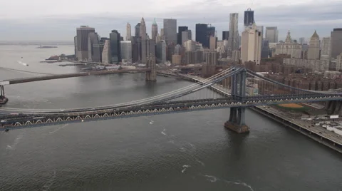 Flying over East River bridges and Pier 17 to approach New York Financial Stock Footage 59165462