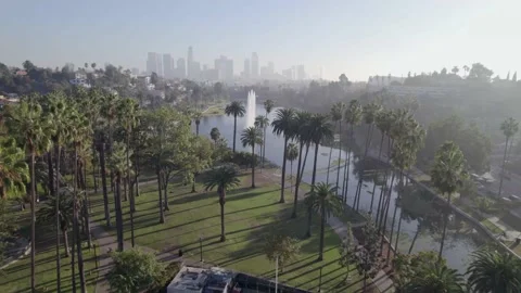 Flying over Echo Park Lake with Downtown Los Angeles in the background Stock Footage 233937552