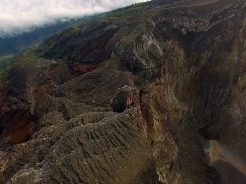 Flying over the edge of Agung volcano crater in Bali, Indonesia (aerial video) Stock Footage 80583122