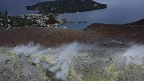 Flying over the edge of Vulcano's Crater with fumaroles, view of Lipari Island Stock Footage 119657428