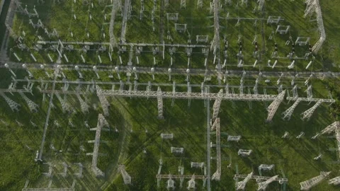 Flying over electrical substation: transformers and grid of pylons and wires Stock Footage 153593220