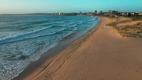 Flying over an empty beach on the northern coast of Sydney Stock Footage 102488889