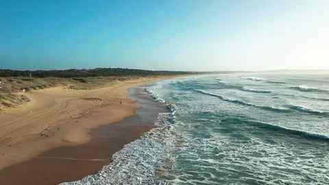 Flying over an empty beach on the northern coast of Sydney Stock Footage 102500515