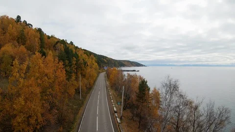 Flying over an empty coastal road in the fall Stock Footage 123954209