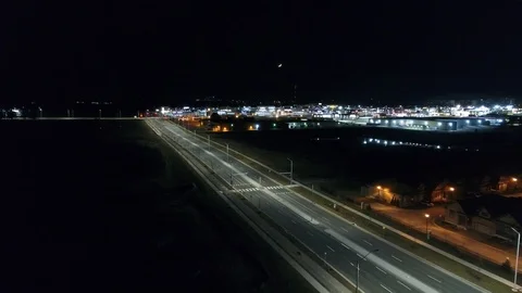 Flying Over Empty Road At Night Near Apartment Buildings And City Complex Wit Stock Footage 107401777
