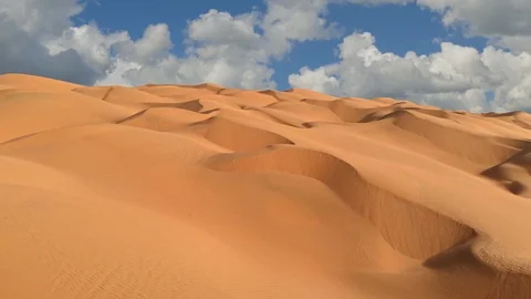 Flying over endless yellow sand dunes in desert. Sand dunes and blue sky with 스톡 동영상 124591381