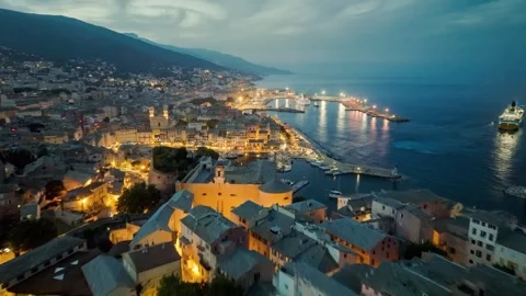 Flying over evening Bastia with city lights, Corsica island. Aerial view of Video stock 246741782