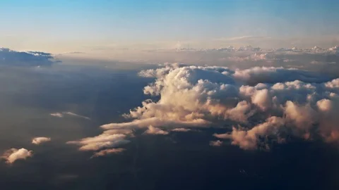 Flying over the evening clouds with the late sun. A view through an window. Video stock 78499920