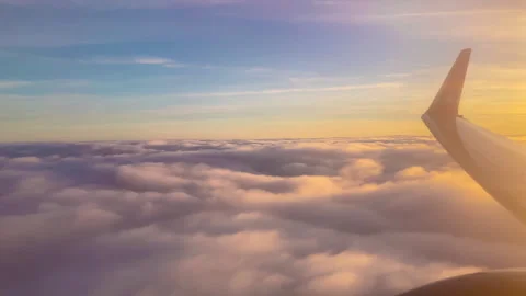 Flying over the evening clouds with the late sun. Seamlessly looped animation Stock Footage 252015825